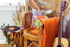 04 a colorful free-spirited nook with a peacock chair, bright textiles, a rattan side table, blooms and some musical instrument