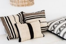 05 a boho meets tribal living room in neutrals, with black touches for drama and a wicker lampshade that hints on a coastal location