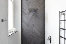 05 a chic contemporary shower space with white walls and an accent graphite grey skinny tiles clad in a chevron pattern and extended to the floor