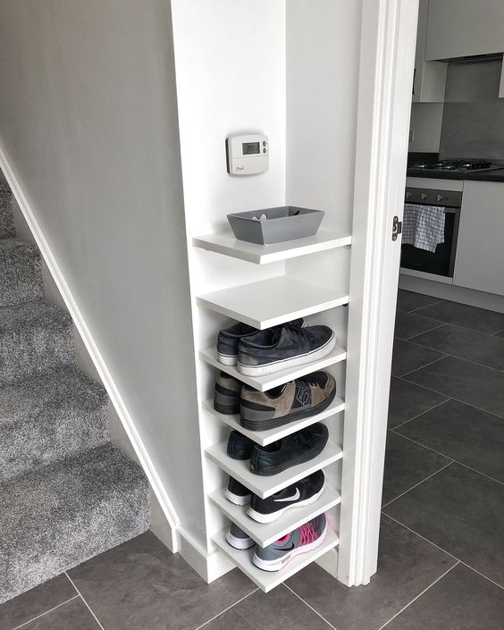 comfortable corner shelves for storing shoes in a tiny entryway are perfect and can be DIYed fast