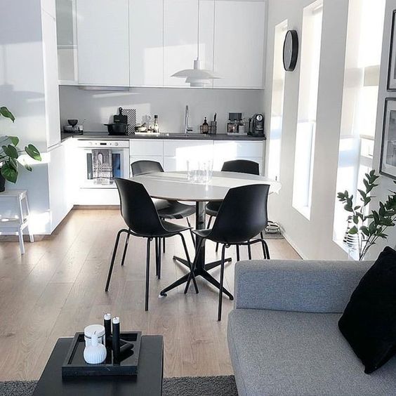 a small minimalist open floor plan done in white, greys and soem black details to make the interior look more chic