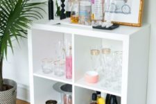 09 a stylish home bar made of an IKEA Kallax shelf with elegant gilded legs features much storage