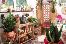 09 a super colorful boho chic nook with a peacock chair styled with a pink cushion and blanket and lots of boho elements around