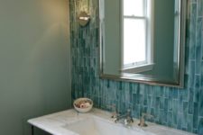 15 a chic vintage-inspired bathroom with mint green walls and a turquoise skinny tile wall plus a marble clad sink