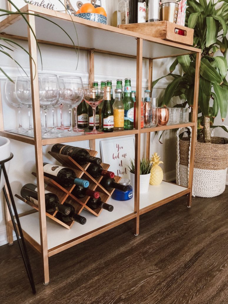 an IKEA Vittsjo shelving unit turned into a chic home bar with copper spray paint, the piece features much storage space