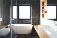 16 a contemporary bathroom all clad with matte dark skinny tiles and refreshed with light colored wood and white pieces