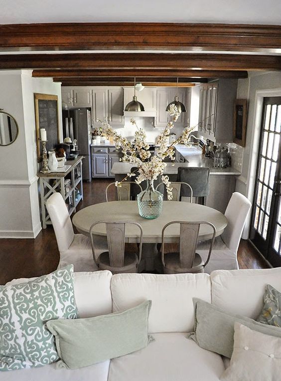 a small farmhouse open layout done in neutrals and with pastel touches looks larger than a dark one could look
