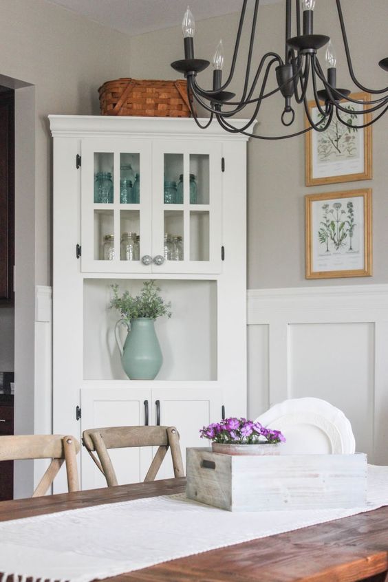 a vintage inspired white corner cabinet is great for displaying all types of tableware and plates