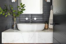 18 a contemporary bathroom with matte black skinny tiles on the wall plus a floating wood and marble vanity
