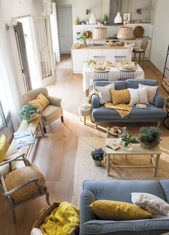 a welcoming open floor plan done with rustic touches, mustard elements and wicker details