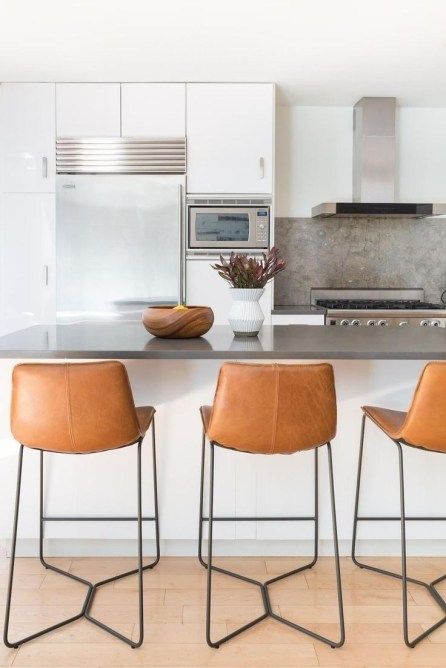 chic brown leather stools with black metal legs look very chic and add a textural touch to the space