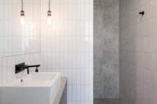 20 a minimalist bathroom done with grey tiles and white skinny ones for an eye-catchy touch
