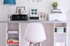 20 a simple contemporary desk of IKEA box shelves and a grey tabletop features open storage units