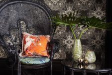 22 a super elegant black peacock chair with a bright pillow and cushion, a matching coffee table and a faux animal skin