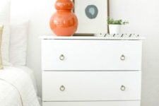 24 an IKEA Tarva dresser hack with white paint, stained legs and ring pulls provides much storage space