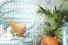 25 mint painted peacock chair with bright and printed textiles and a matching coffee table next to it bring a subtle touch of color