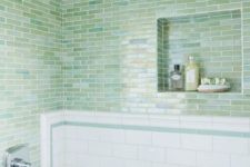 26 green blue skinny tiles clad horizontally paired with white subway tiles make up a stylish look