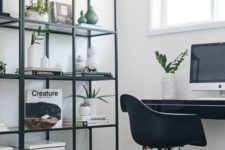 a Nordic black and white home office with a printed rug, a black shelving unit and desk plus a chair