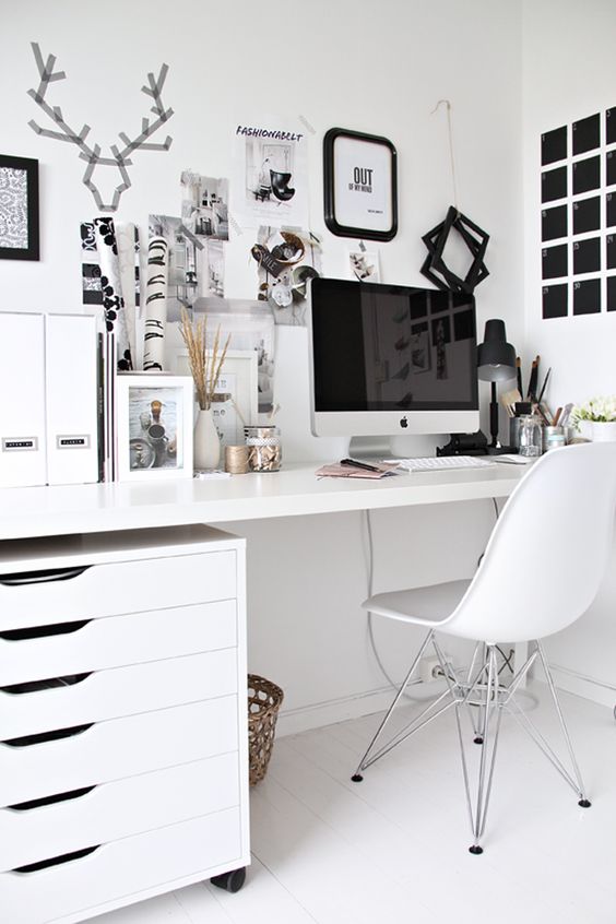 a Scandinavian home office done in mostly white, with a black noteboard and some more touches for an accent