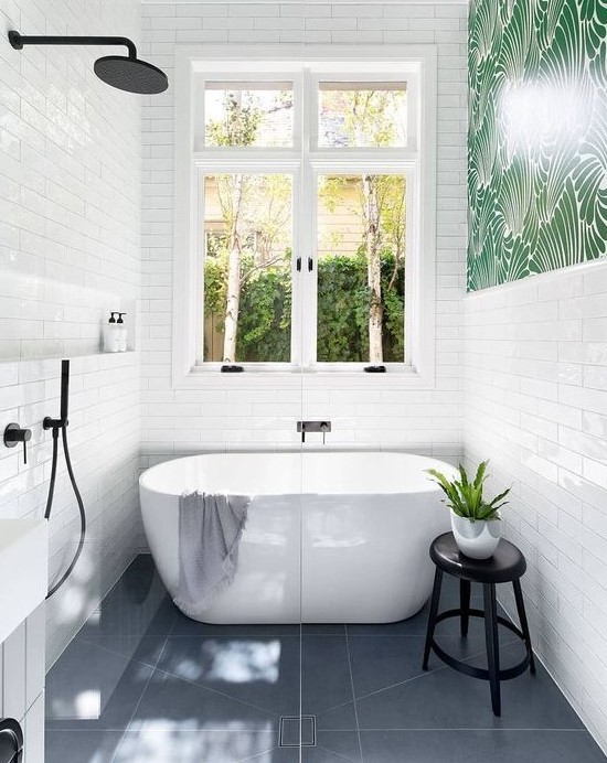 a bold contemporary bathroom with white skinny tiles, grey tiles on the floor and black hardware
