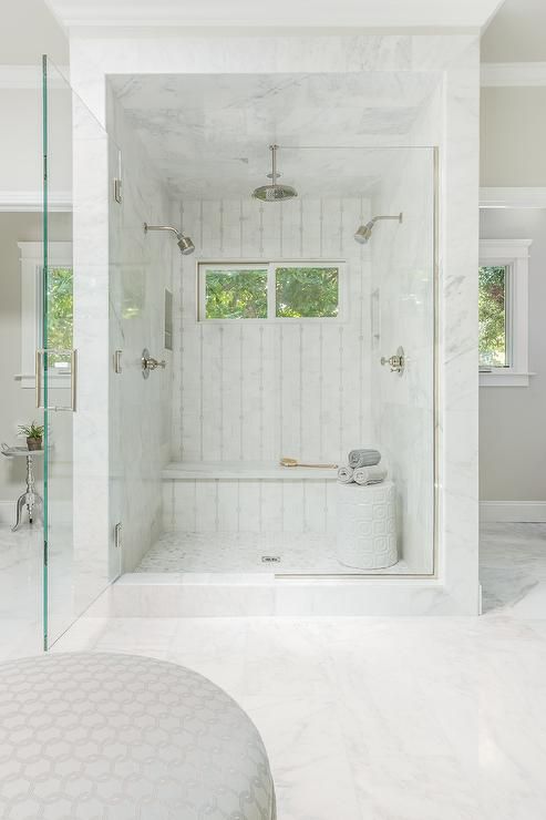 a mini marble shower space with windows and a built in bench plus a side table with towels a mini marble shower space with windows and a built-in bench plus a side table with towels