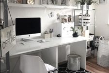 a simple black and white home office with a printed rug, white furniture, a metal shelving unit