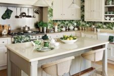 a vintage-inspired tropical kitchen with creamy cabinets and tropical leaf wallpaper wall over plus wicker stools