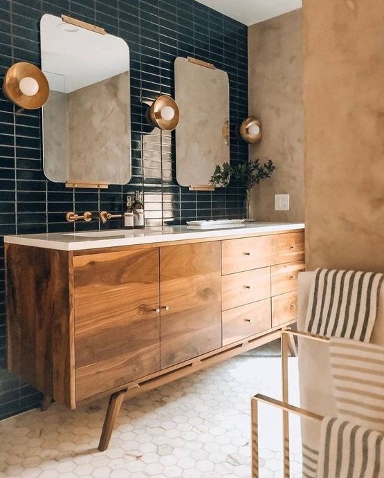 an elegant bathroom with navy skinny and white hexagon tiles, a rich stained vanity, cool mirrors and lamps is amazing