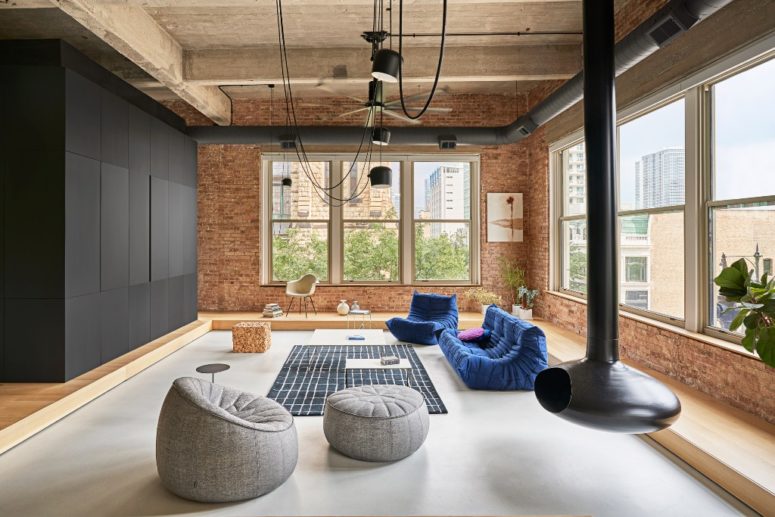 This is a living room zone done with bright contemproary furniture, a suspended fireplace and a black cube for storage and space division This is a living room zone done with bright contemproary furniture, a suspended fireplace and a black cube for storage and space division