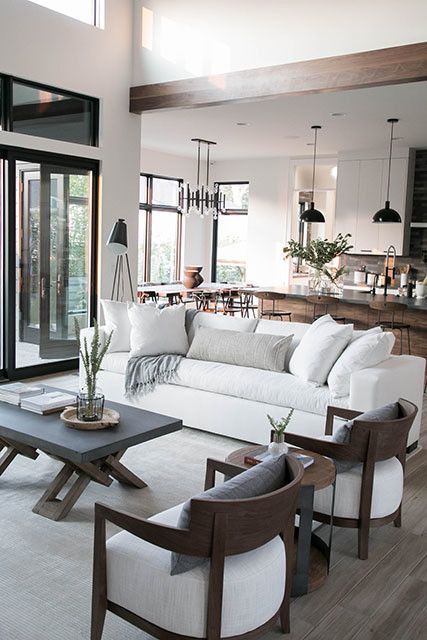 a modern neutral living room with a white sofa as a centerpiece of the space and all the rest of the furniture around