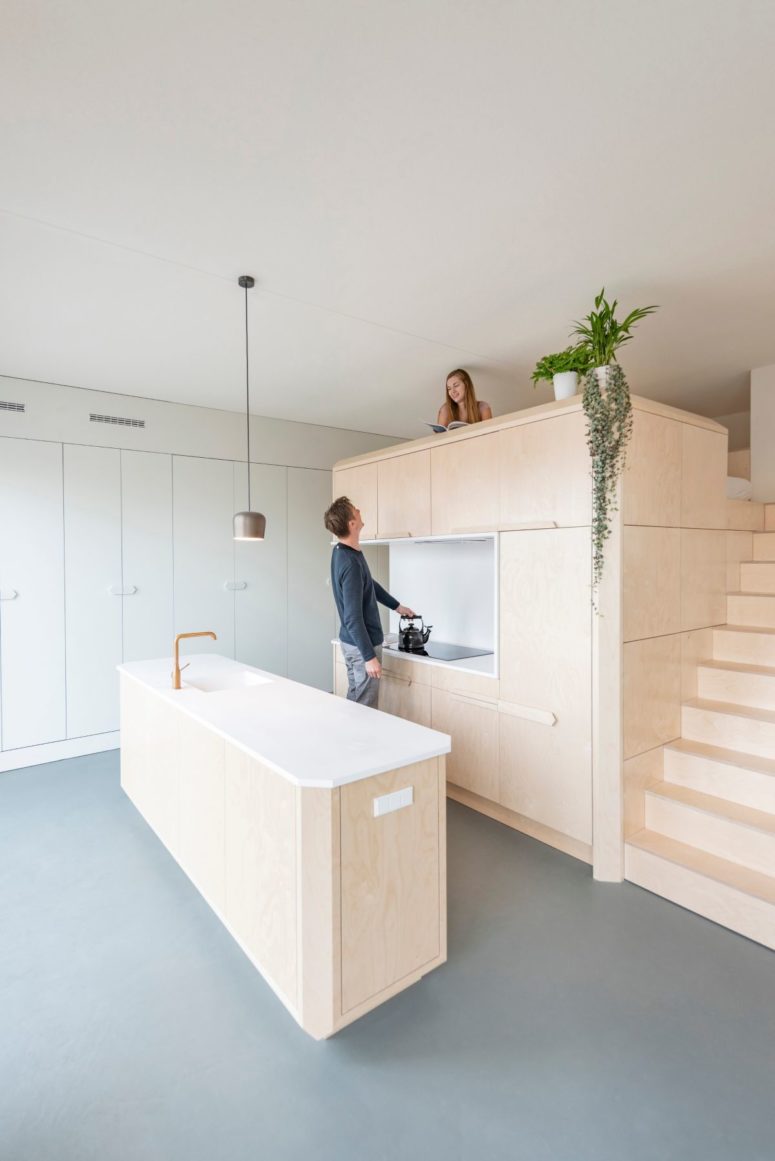 The kitchen is done with sleek light colored wooden cabinets, stone countertops and kitchen cabinets with much storage The kitchen is done with sleek light-colored wooden cabinets, stone countertops and kitchen cabinets with much storage