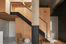 03 There’s a minimalist staircase and a wooden platform plus some catchy furniture