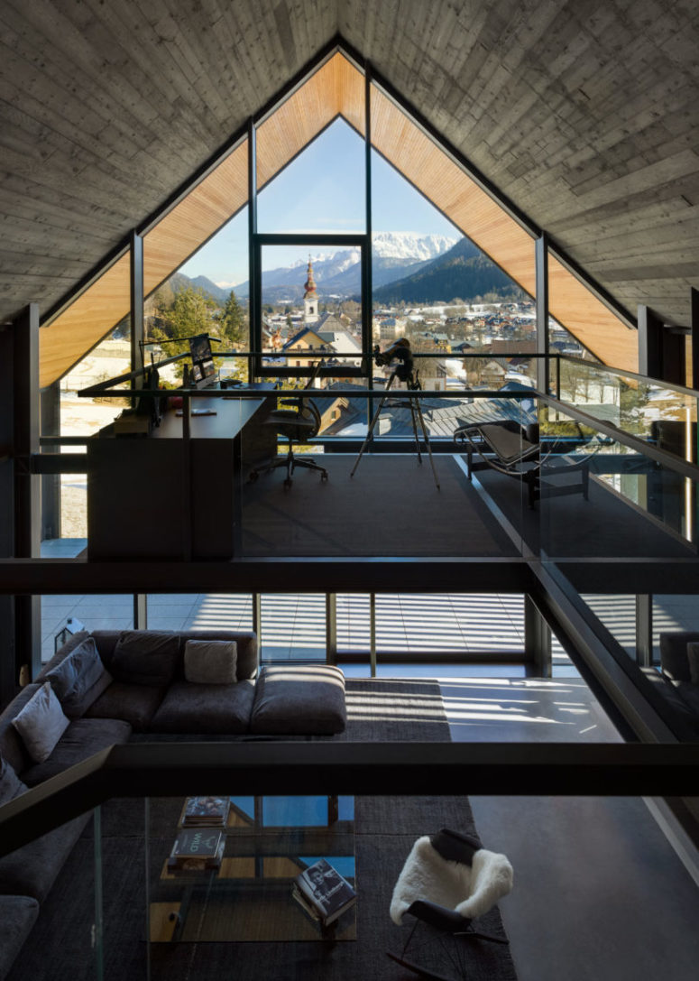 an awesome home office with a view The home office is located on the upper floor and allows enjoying the views through a glazed wall
