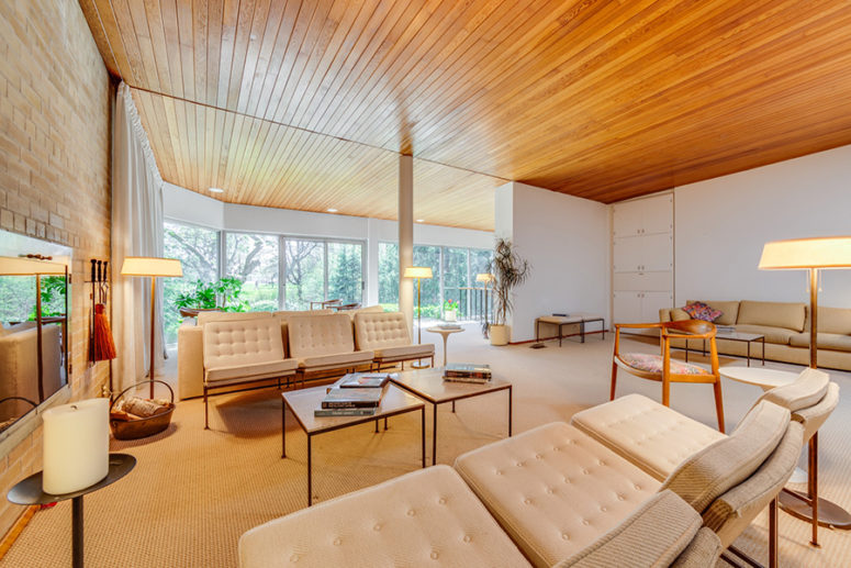 The living room is done with elegant creamy tufted sofas, lamps here and there and a built in fireplace in a brick wall The living room is done with elegant creamy tufted sofas, lamps here and there and a built-in fireplace in a brick wall