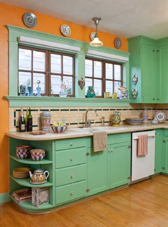 a super bright kitchen done in orange and green, with some neutral touches for calming down the space