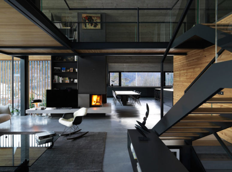 a built in fireplace is always a great focal point The spaces seamlessly flow into each other, a built-in fireplace brings coziness to all of them