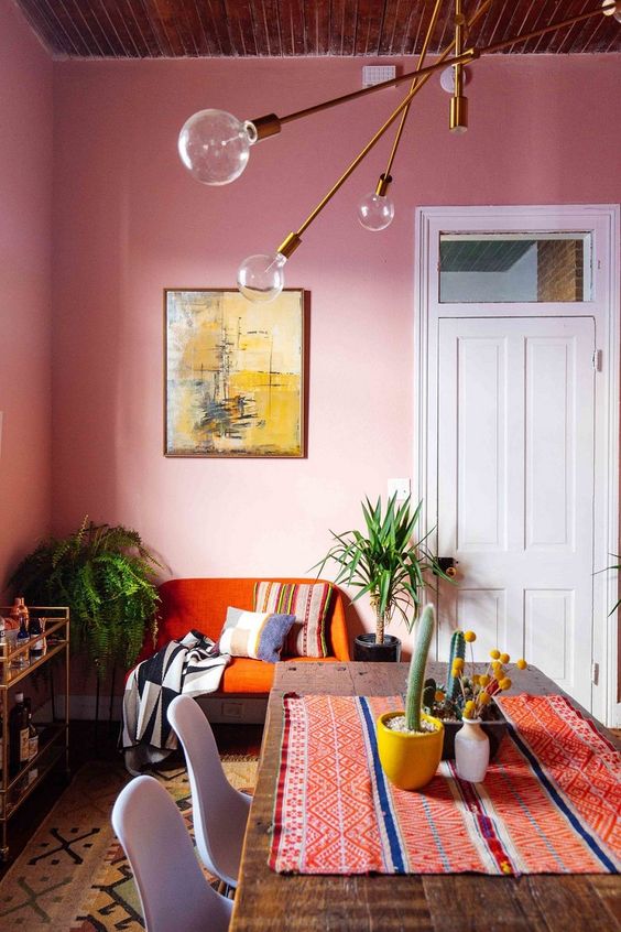 a colorful retro spce in pink, orange and with touches of fun folksy and boho patterns