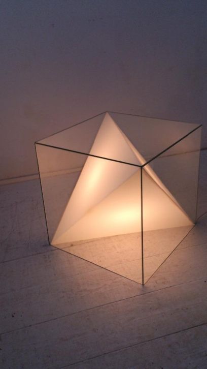 a gorgeous coffee table plus a lamp inside done as a cube and a triangle inside is a chic and cool idea
