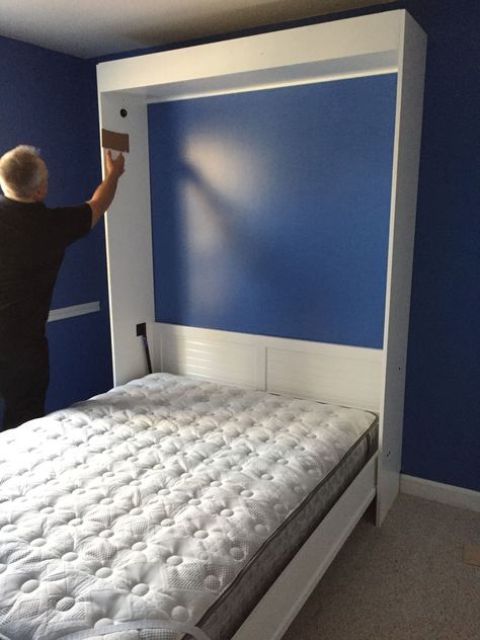 a vertical Murphy bed with a mattress attached with Velcros - you won't have to move it every time
