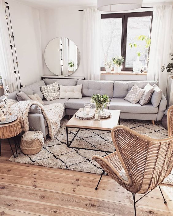a large grey sectional sofa placed in front of the window and all the furniture arranged around it