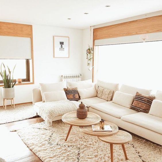 a large creamy sectional sofa in front of the window is a strategical idea that allows much light into the room