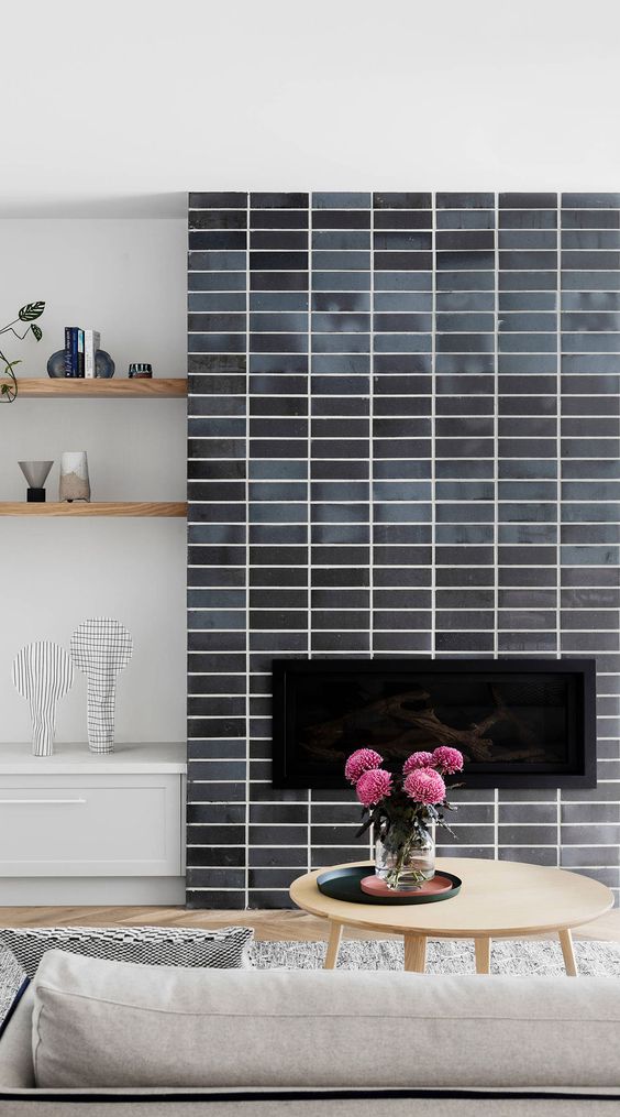a fireplace clad with grey skinny tiles is a stylish idea for a mid-century modern living room, it looks nice