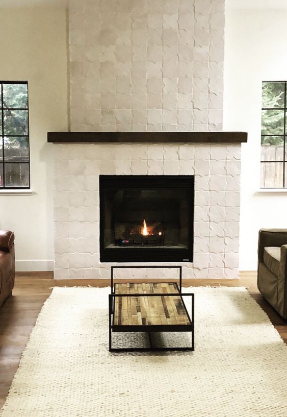 a fireplace with a white star-shaped Zellige tile surround is a beautiful and eye-catching feature for styling a space