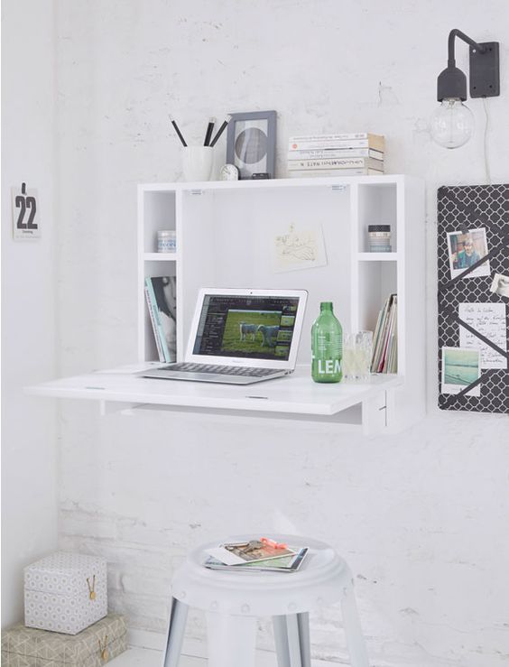 a minimalist white Murpy desk with storage compartments and a small desktop plus a white stool for an airy space