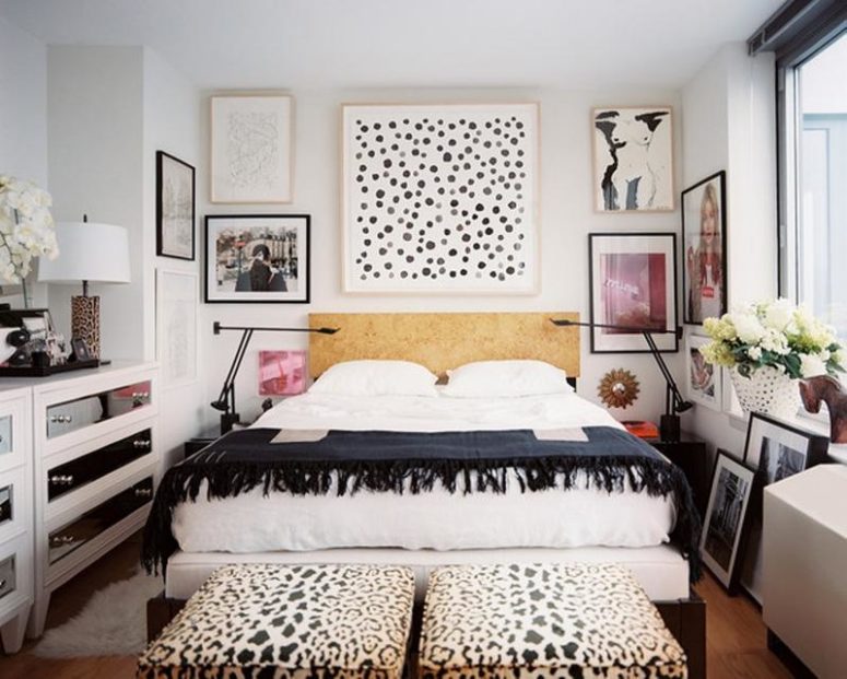 a monochromatic eclectic bedroom with a dashing gallery wall, two animal printed ottomans and mirrored dressers