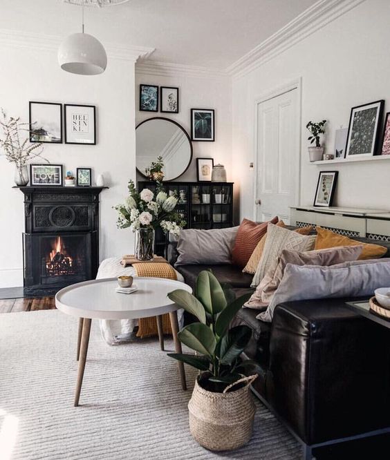a-monochromatic-eclectic-living-room-with-a-vintage-fireplacea-bookcase-a-leather-sofa-and-contemporary-ottomans.jpg
