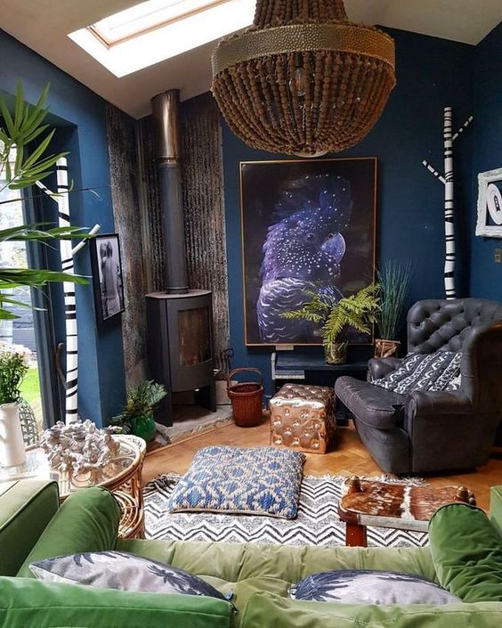 a-moody-eclectic-living-room-with-navy-walls-black-and-green-furniture-a-bead-chandelier-and-a-vintage-hearth.jpg