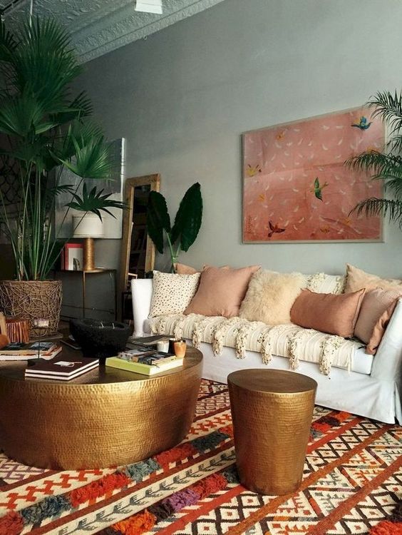 a-moody-eclectic-space-with-a-statement-artwork-a-boho-printed-rug-lots-of-earthy-pillows-and-metal-hammered-items.jpg