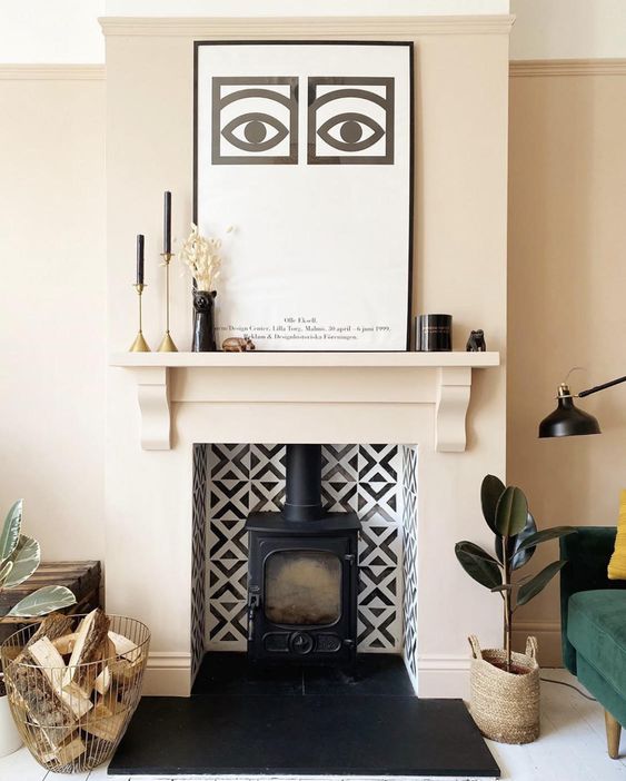 a niche clad with black and white tiles, with a black hearth inside is a stylish solution for a living room, this hearth will bring warmth and coziness