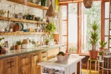 a rustic meets boho kitchen with Moroccan lanterns, wooden cabinets and a shabby chic kitchen island